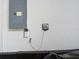 Close up of the electrical box and sprinkler timer mounted on the wall at 1167 Rotonda Cir, Rotonda West, FL 33947