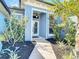 Beautiful front entrance with lush landscaping and a welcoming doorway with glass features at 1167 Rotonda Cir, Rotonda West, FL 33947