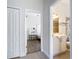 Bright hallway leads to a bathroom and a bedroom with a vanity and workstation at 1167 Rotonda Cir, Rotonda West, FL 33947