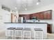 Modern kitchen featuring stainless steel appliances, a breakfast bar, and elegant chandelier lighting at 1167 Rotonda Cir, Rotonda West, FL 33947