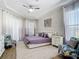 Serene main bedroom with soft lavender accents, decorative wallpaper, and bright windows at 1167 Rotonda Cir, Rotonda West, FL 33947