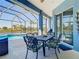 Outdoor dining area on the lanai overlooking the pool and waterfront view at 1167 Rotonda Cir, Rotonda West, FL 33947