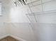 Walk-in closet with extensive metal shelving and wood floor at 1167 Rotonda Cir, Rotonda West, FL 33947