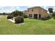 Manicured backyard with lush lawn and mature landscaping, ideal for outdoor enjoyment at 11750 Tempest Harbor Loop, Venice, FL 34292