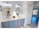 Bathroom features a double vanity with oval mirrors, modern lighting, and white shiplap walls at 11750 Tempest Harbor Loop, Venice, FL 34292