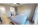 Neutral bedroom features ceiling fan, closet, and en suite bathroom at 11750 Tempest Harbor Loop, Venice, FL 34292