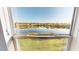 Scenic lake view from the window showcases tranquil water and surrounding landscape at 11750 Tempest Harbor Loop, Venice, FL 34292