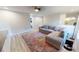 Living room features sectional sofa, modern lighting and decor, and an accent rug at 11750 Tempest Harbor Loop, Venice, FL 34292