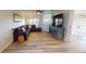 Living room with couch, stylish cabinet, hardwood floors, and bright natural light at 11750 Tempest Harbor Loop, Venice, FL 34292