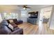 Comfortable living room featuring a large sectional sofa, modern ceiling fan, and views of the water at 11750 Tempest Harbor Loop, Venice, FL 34292