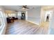 Inviting living room featuring modern light wood floors, a ceiling fan, and an open floor plan at 11750 Tempest Harbor Loop, Venice, FL 34292