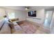 Bright living room features a comfortable sectional sofa, a large rug, and built-in cabinets at 11750 Tempest Harbor Loop, Venice, FL 34292