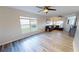 Open living room with wood floors, ceiling fan, and lots of natural light at 11750 Tempest Harbor Loop, Venice, FL 34292