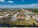 Aerial view of a community featuring well-maintained homes, a pond, and convenient access to the highway at 13100 S Mccall Rd # 112, Port Charlotte, FL 33981