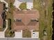 Birds eye view of a house with a brown roof showing driveway, sidewalk, and surrounding vegetation at 13100 S Mccall Rd # 112, Port Charlotte, FL 33981