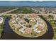 Aerial view highlighting the neighborhood's convenient location near the highway, lush landscaping, and tranquil waterfront property at 13100 S Mccall Rd # 112, Port Charlotte, FL 33981