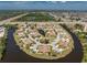 Wide aerial view of a picturesque waterfront community with lush landscaping and community ponds at 13100 S Mccall Rd # 112, Port Charlotte, FL 33981
