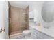 Bathroom featuring modern shower with glass doors and neutral tiles, plus a classic vanity at 13100 S Mccall Rd # 112, Port Charlotte, FL 33981