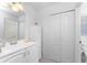 Well-lit bathroom featuring a vanity and sink, white cabinets, and a mirror for a clean and classic look at 13100 S Mccall Rd # 112, Port Charlotte, FL 33981