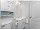 Compact and clean bathroom with a well-maintained vanity and toilet, complemented by a storage cabinet at 13100 S Mccall Rd # 112, Port Charlotte, FL 33981