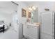 Bright bathroom with vanity and decor, offering a glimpse into an adjacent bedroom space at 13100 S Mccall Rd # 112, Port Charlotte, FL 33981