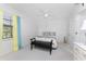 Bright and airy bedroom with plush carpeting, modern ceiling fan, and window with colorful curtains at 13100 S Mccall Rd # 112, Port Charlotte, FL 33981