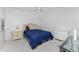 Spacious bedroom showcasing a bed with blue comforter, a ceiling fan, and neutral-toned carpet at 13100 S Mccall Rd # 112, Port Charlotte, FL 33981