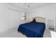 Comfortable bedroom featuring a blue comforter, ceiling fan, and closet space for storage at 13100 S Mccall Rd # 112, Port Charlotte, FL 33981