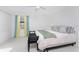 Bright bedroom featuring a comfortable bed, soft carpet, and a window with stylish curtains at 13100 S Mccall Rd # 112, Port Charlotte, FL 33981