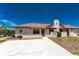 Attractive home exterior with a pathway leading to the front door, complemented by well-maintained landscaping at 13100 S Mccall Rd # 112, Port Charlotte, FL 33981