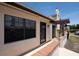 Detailed view of the home's exterior showcasing a covered entryway, brick accents, and a well-lit doorway at 13100 S Mccall Rd # 112, Port Charlotte, FL 33981