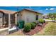 Charming exterior view featuring well-maintained landscaping and a side patio at 13100 S Mccall Rd # 112, Port Charlotte, FL 33981