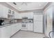 Bright kitchen featuring ample white cabinetry, tile backsplash and modern appliances at 13100 S Mccall Rd # 112, Port Charlotte, FL 33981