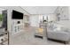 Open-plan living room features a ceiling fan, and view to kitchen and front door at 13100 S Mccall Rd # 112, Port Charlotte, FL 33981