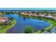 Community aerial view showcases many homes surrounding a large lake and preserve at 13335 Golf Pointe Dr, Port Charlotte, FL 33953