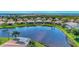 Community aerial view showcases many homes surrounding a large lake and preserve at 13335 Golf Pointe Dr, Port Charlotte, FL 33953
