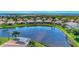 Community aerial view showcases many homes surrounding a large lake and preserve at 13335 Golf Pointe Dr, Port Charlotte, FL 33953