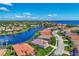 Scenic aerial view showcasing waterfront homes and lush landscaping on a sunny day at 13335 Golf Pointe Dr, Port Charlotte, FL 33953