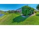 Manicured lawn and garden beds surround the screened-in patio of this lovely home at 13335 Golf Pointe Dr, Port Charlotte, FL 33953