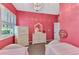 Bright bedroom with two twin beds, stylish decor, and a large dresser at 13335 Golf Pointe Dr, Port Charlotte, FL 33953