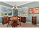 Charming dining area features a chandelier, two windows with shutters, and furniture at 13335 Golf Pointe Dr, Port Charlotte, FL 33953