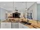 Modern kitchen with stainless appliances, granite counters, breakfast bar, and open layout to living area and lanai at 13335 Golf Pointe Dr, Port Charlotte, FL 33953