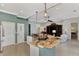 Open kitchen features granite countertops, stainless steel appliances, and a breakfast bar overlooking the living area at 13335 Golf Pointe Dr, Port Charlotte, FL 33953