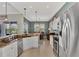 Bright kitchen featuring granite countertops, stainless steel appliances, and access to the dining and lanai areas at 13335 Golf Pointe Dr, Port Charlotte, FL 33953