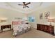 Comfortable main bedroom featuring a ceiling fan, a decorative headboard, and two matching dressers at 13335 Golf Pointe Dr, Port Charlotte, FL 33953