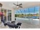 Relaxing pool area with a screened-in patio overlooking a scenic lake view at 13335 Golf Pointe Dr, Port Charlotte, FL 33953