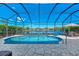 Sparkling in-ground pool within a screened enclosure with beautiful lake views at 13335 Golf Pointe Dr, Port Charlotte, FL 33953