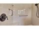 Bathroom shower features a niche, grab bars, and modern fixtures at 13335 Golf Pointe Dr, Port Charlotte, FL 33953