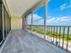 Large screened lanai with gray wood-look floors and views of the water at 1400 Beach Rd # 2, Englewood, FL 34223