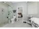 Bathroom with toilet, glass shower, and soaking tub with view into bedroom at 1400 Beach Rd # 2, Englewood, FL 34223
